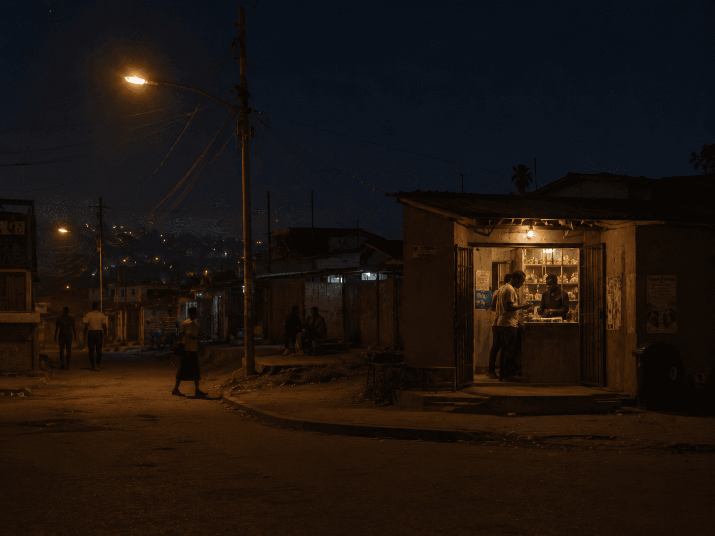 A lit market kiosk at night